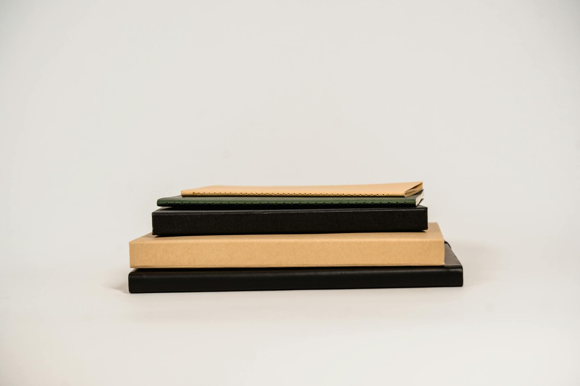 Modern stack of books and notebooks on a clean white background